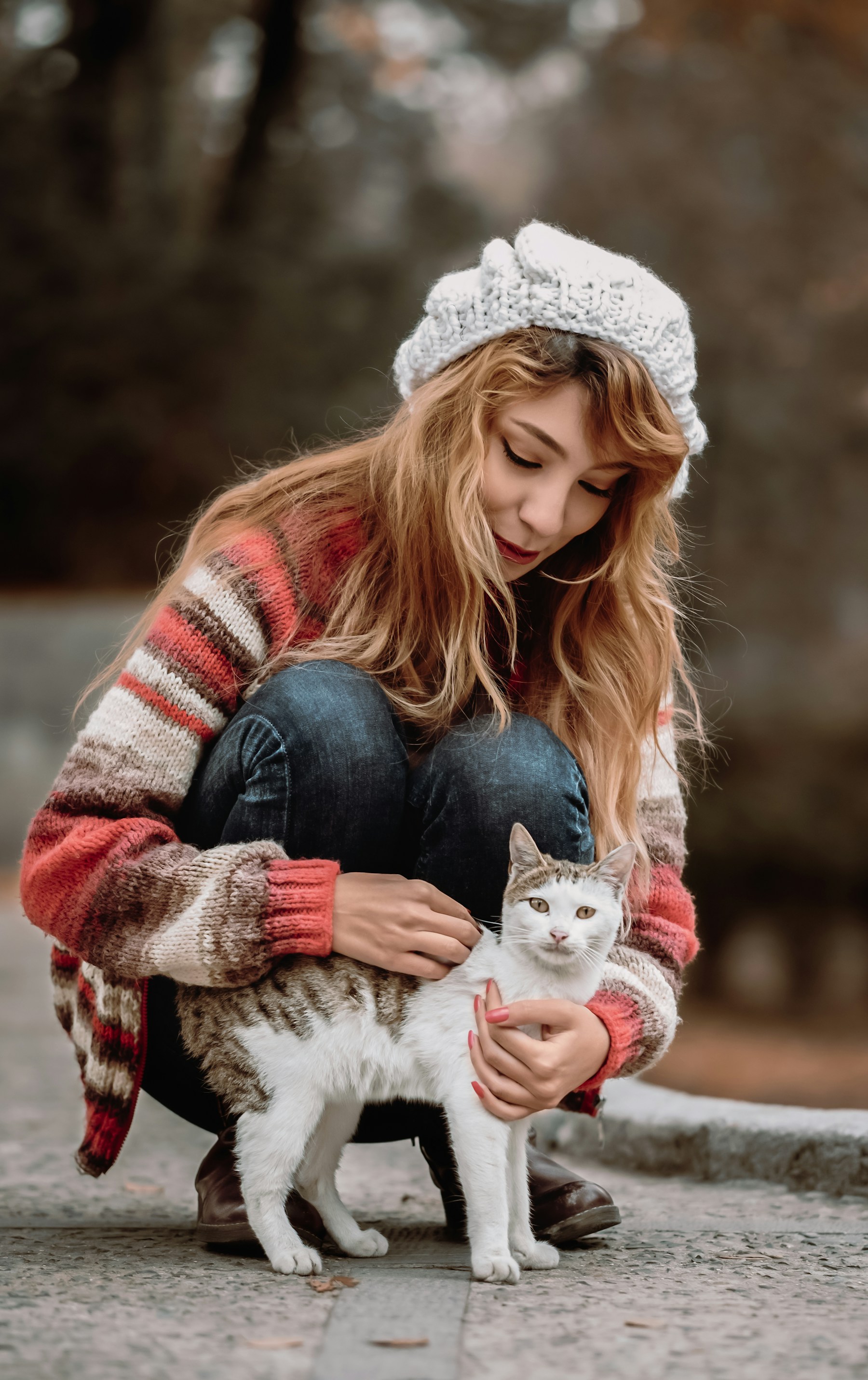 A woman sitting beside her cat
